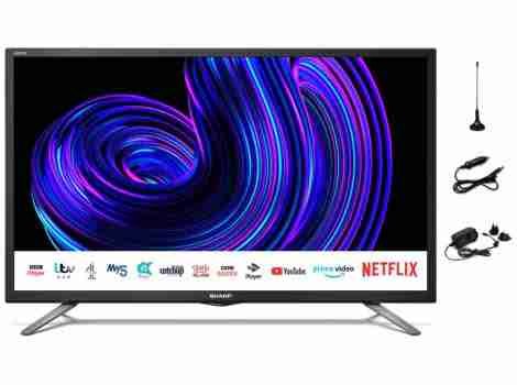 Sentence with product name: Modern Sharp 24 Inch Smart LED 12v 24v TV with Freeview Prime Netflix Satellite displaying vibrant abstract art with various connectivity options and streaming service logos visible on the screen.